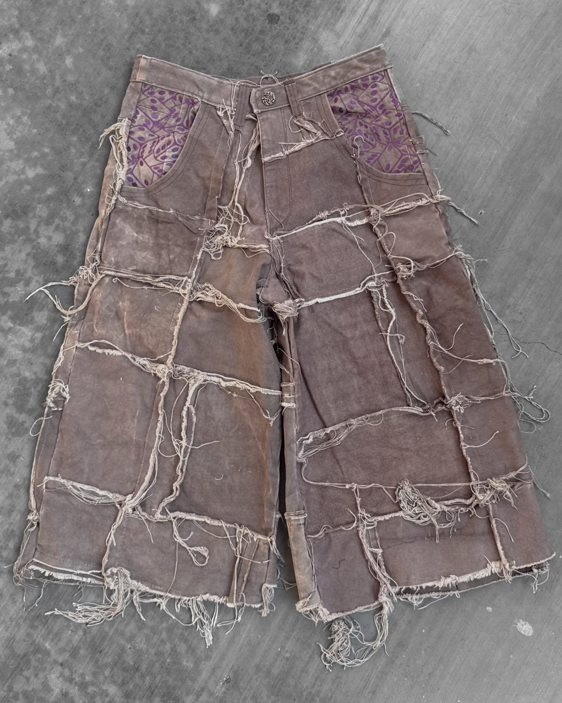 Patchwork pants on a textured gray surface
